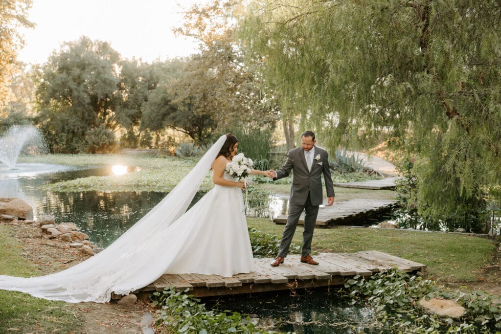 bride and groom walking across bridge at Galway downs Temecula